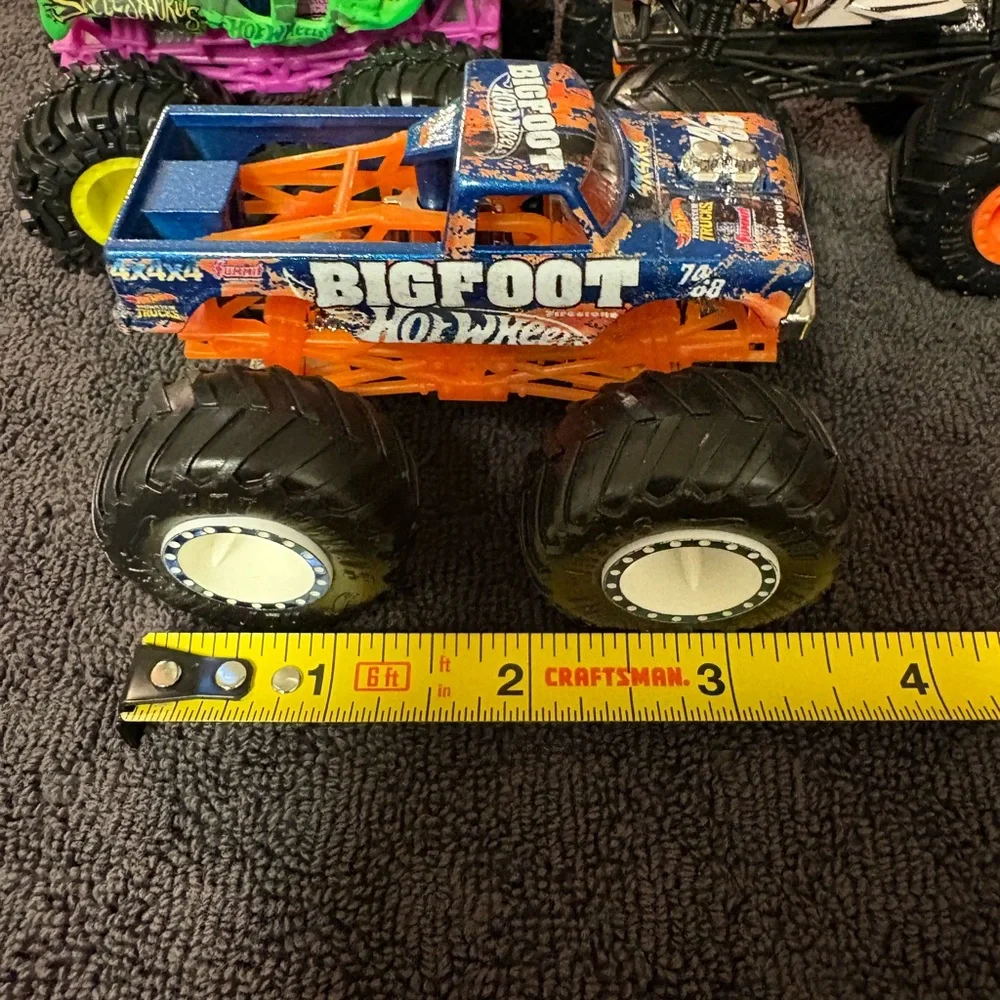 Hot Wheels 4 lot of Monster Truck Toys. Assorted Colors (Green, Orange, Blue)